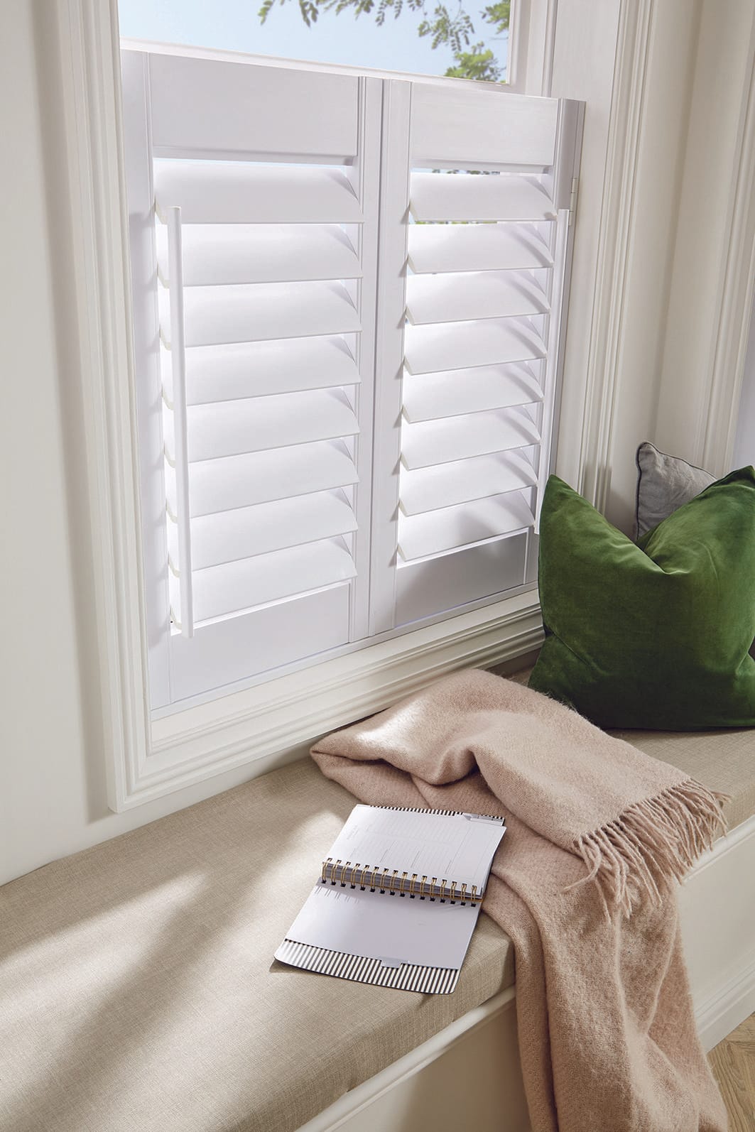 Cafe-style plantation shutters on a Belfast bay window seat