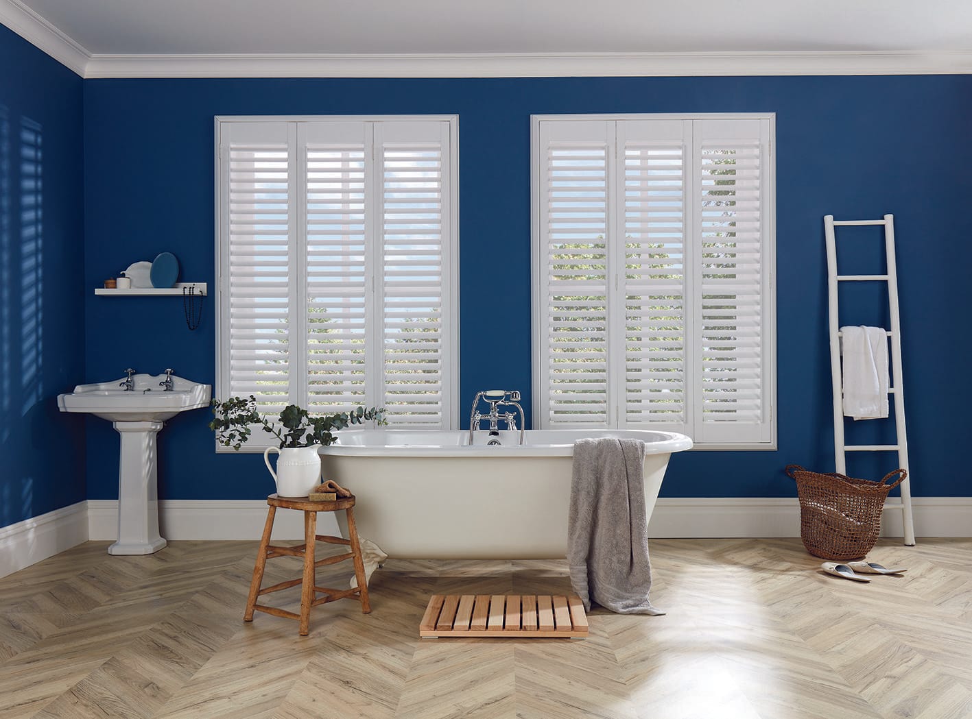 Waterproof full-height plantation shutters at a bathroom window